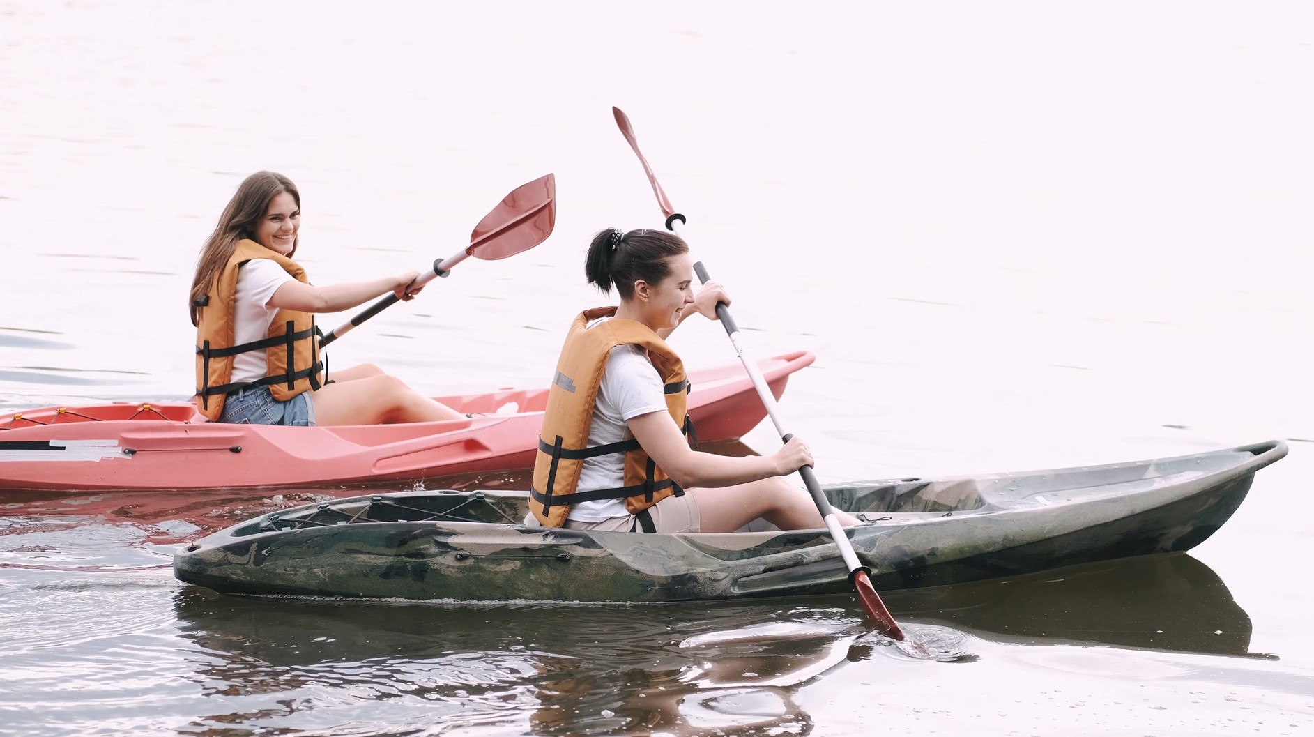 Two women paddling on a lake